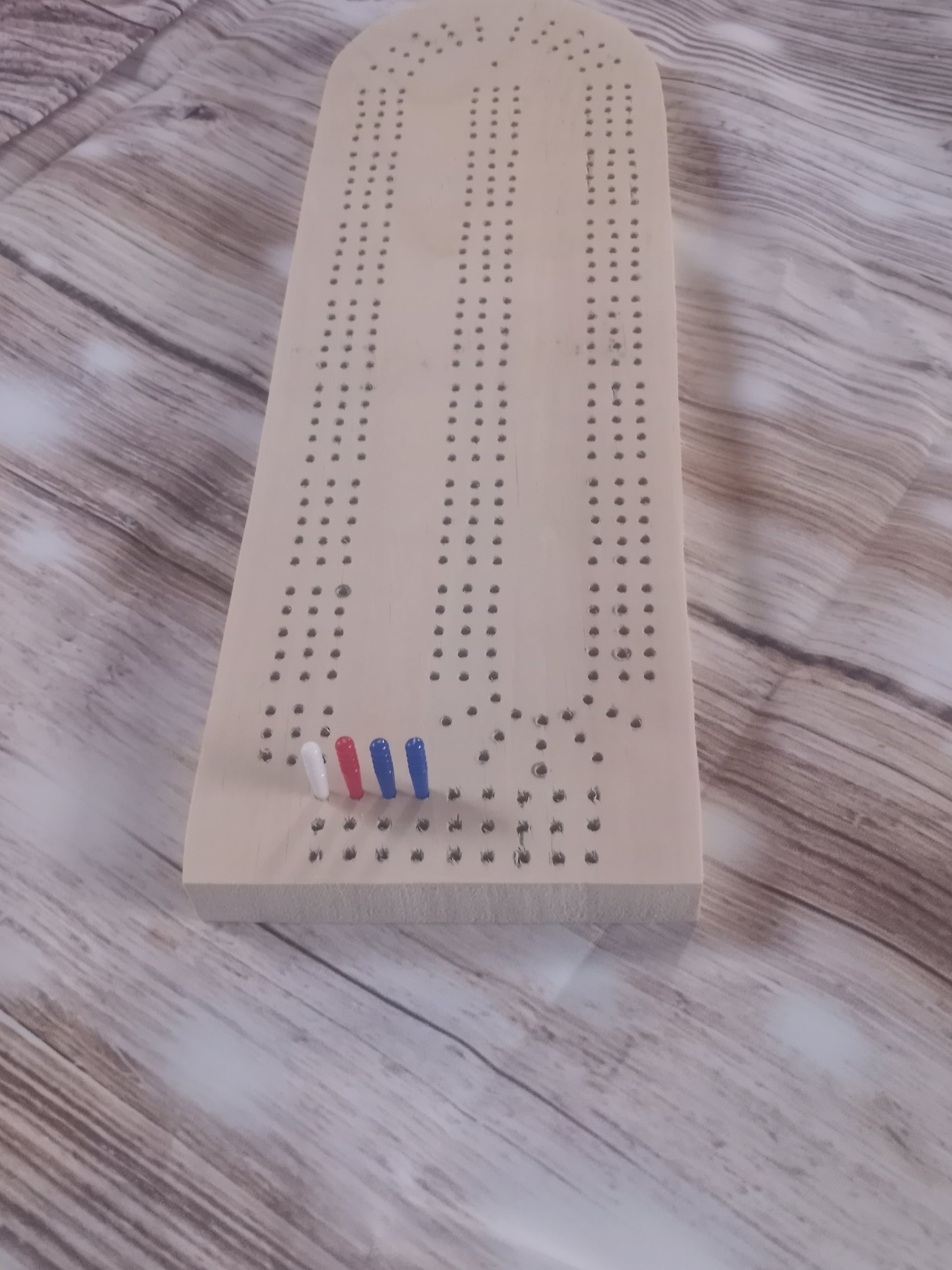 handmade cribbage board on pine wood